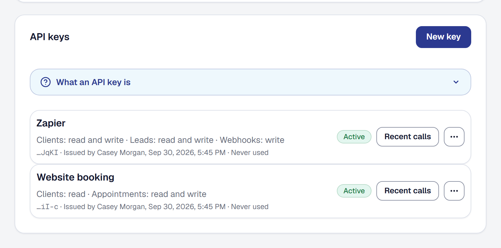 The API keys panel on the Integrations page: a Zapier key that may read and write clients and leads and manage webhooks, and a Website booking key that may read clients and book appointments, each Active, with who issued it and whether it has been used.